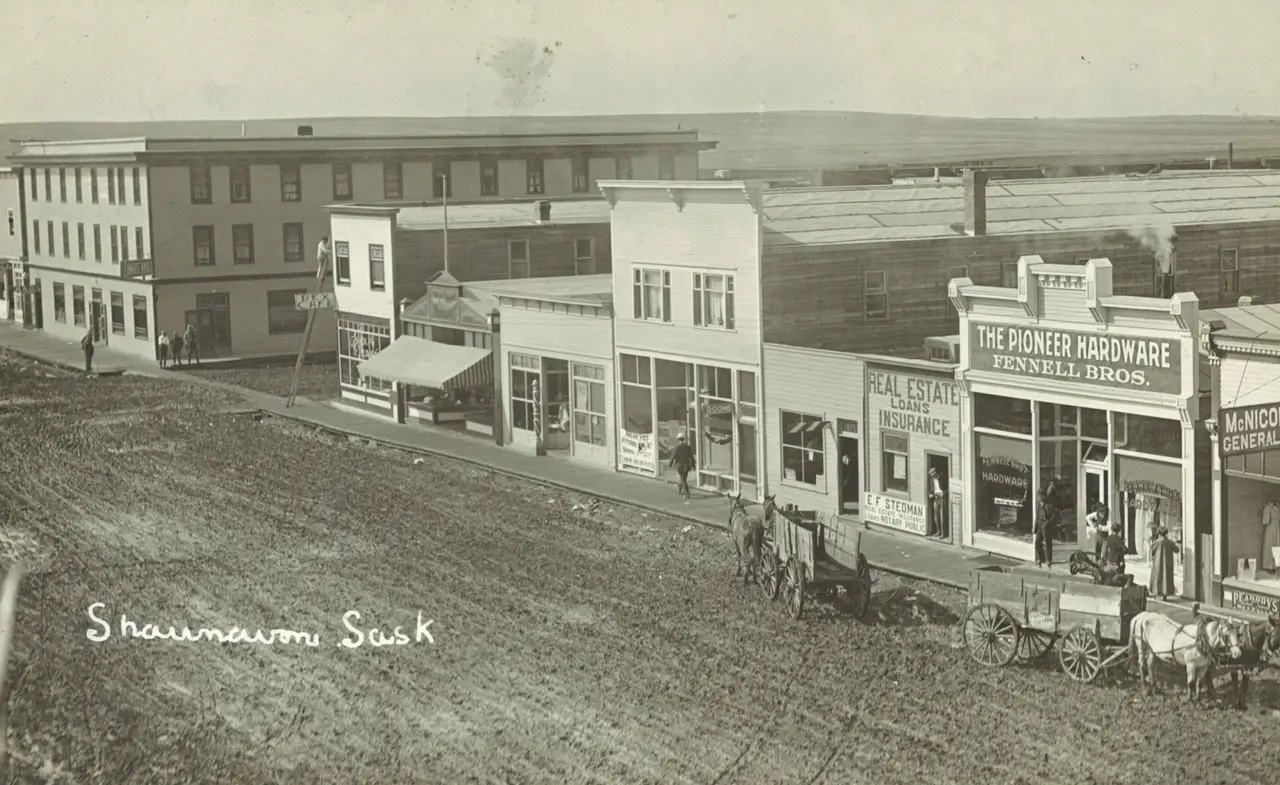 Main Street with Pioneer Hardware and horse-drawn wagons, about 1910